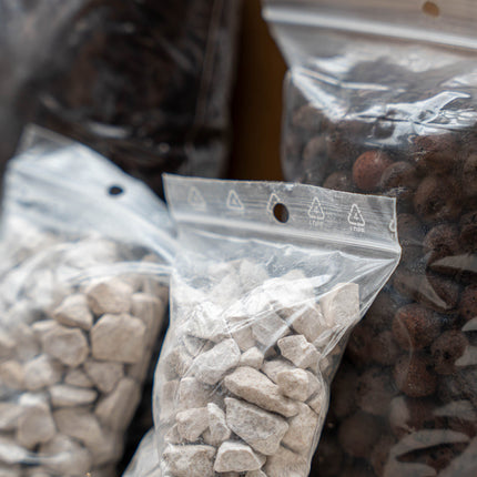 Clear plastic bags containing stones.
